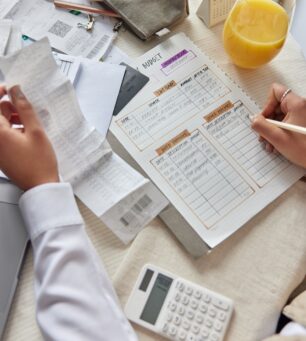Cropped,Shot,Of,Unrecognizable,Woman,Sits,At,Table,With,Receipt