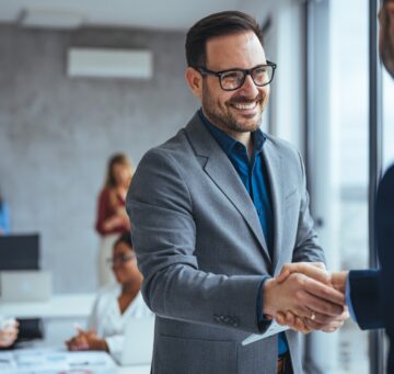 Shot,Of,Two,Businessmen,Shaking,Hands,In,An,Office.,Two