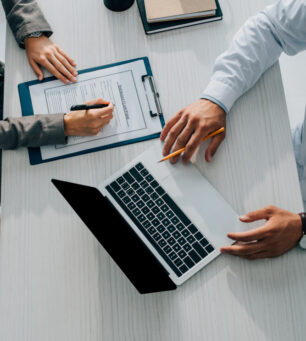 Cropped,Image,Of,Patient,Signing,Insurance,Claim,Form,In,Clinic,